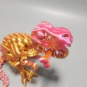 Macro shot of 3D printed dinosaur skeleton with pink and gold gradient metallic finish