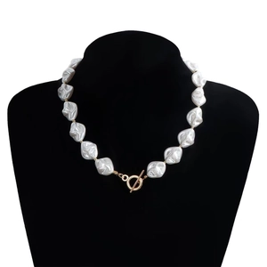 Detailed macro shot of baroque irregular pearl necklace with gold metal OT toggle clasp