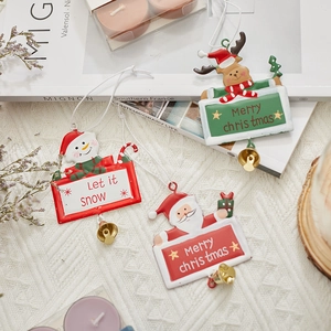 Christmas metal ornaments featuring Santa, reindeer, and snowman with gold bells
