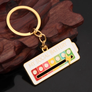 Macro shot of slider on gold metal my social battery keychain on vintage wood base