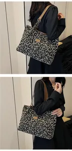 Macro detail of leopard print tote bag featuring leather straps and stylish chain accent