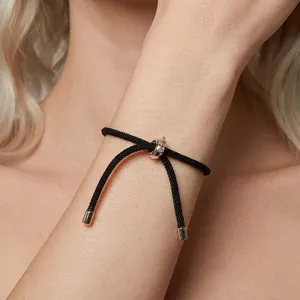 Adjustable black woven rope bracelet with s925 sterling silver slider on a female wrist