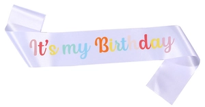 Detail of purple satin birthday sash with colorful It's My Birthday lettering