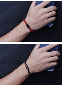Detail of red and coffee braided leather bracelets with matte black magnetic clasps