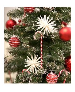 Close-up of red ornaments and candy cane decorations on a festive Christmas tree