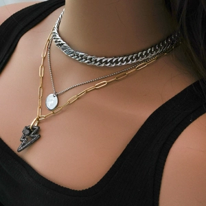 Three-layer necklace featuring silver tank chain, coin pendant, and golden lightning bolt