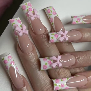 Long coffin french fake nails with pink floral patterns and 3D bow accessories