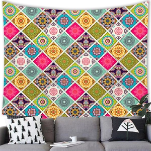 Detailed view of colorful mandala tapestry hanging over a sofa in a boho living room