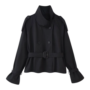 Detail of black cropped trench coat with high collar, double-breasted buttons, and waist belt