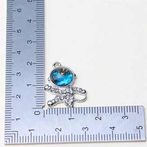 Detailed view of silver astronaut charm with blue starry visor and white rhinestones