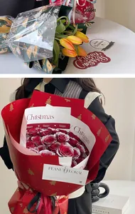 Detail of Christmas waterproof floral wrapping paper with gold tree patterns and roses
