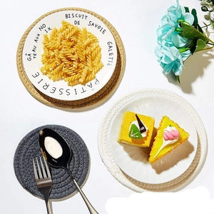 Flat lay of thick round woven cotton placemats in neutral tones for table protection