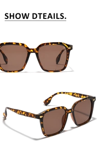 Detail of oversized square tortoiseshell sunglasses with brown lenses and gold rivets