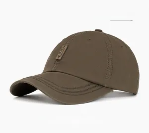 Detail of military green washed cotton baseball cap featuring a leather patch with metal rivet