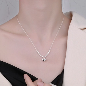 Elegant S925 sterling silver heart pendant necklace worn by a professional model