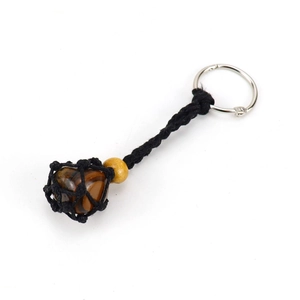 Detail of hand-woven black mesh pouch keychain with natural tiger eye stone and wood beads