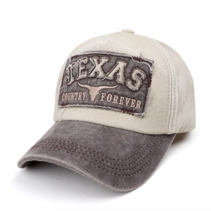Macro detail of vintage washed cotton baseball cap with Texas embroidery and distressed brim