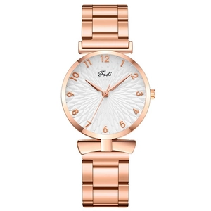 Detail of a rose gold women's watch featuring a white textured dial and metallic strap