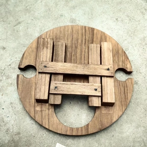 Top view of portable wooden folding picnic table showing natural grain and wine glass slots