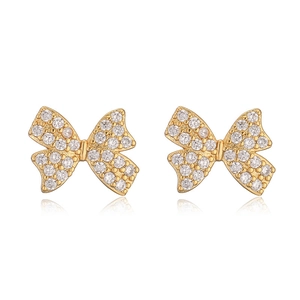 18K gold-plated bow earrings with clear zircons on a white background with reflection