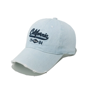 Detailed close-up of distressed denim baseball cap with California embroidery