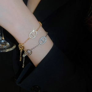 Close-up of gold and silver plated oval link bracelets with pavé cubic zirconia