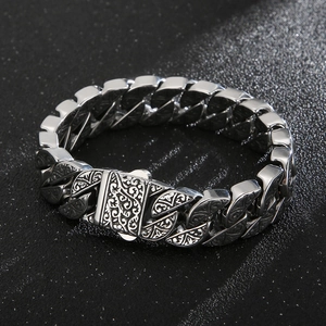 Detailed view of silver titanium steel Cuban bracelet with vintage engraved floral patterns