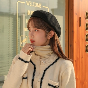 Elegant black wool beret hat for women shown on model in warm autumn sunset light