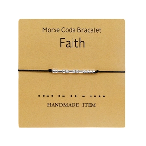 Handmade Morse code bracelet with black cord and silver beads on Faith themed card