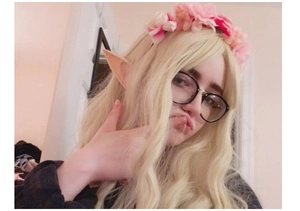 Cosplay elf ears and pink flower headband accessory shown on a blonde character model