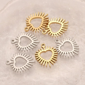 Golden and silver stainless steel hollow heart pendants with radiant sunburst edges for DIY