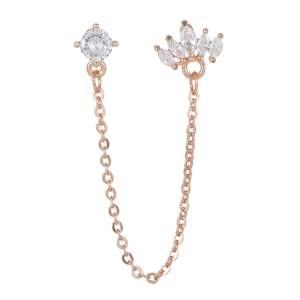 Macro view of rose gold chain piercing jewelry with round and marquise cubic zirconia gems