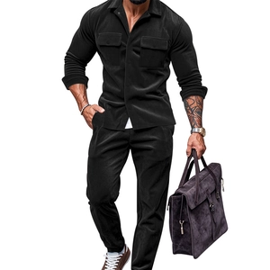 Detail view of men's black suede jacket and trousers set with chest pockets