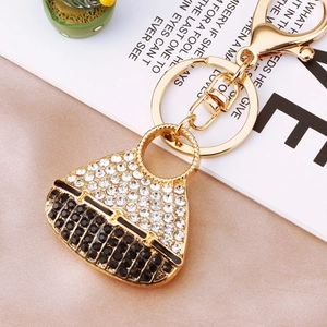 Detailed close-up of a luxury mini handbag keychain with sparkling rhinestones and gold ring