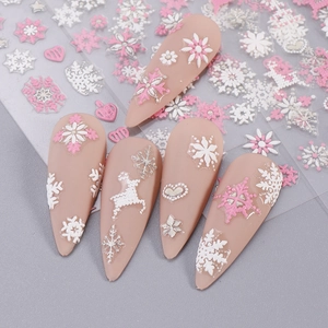Detailed view of 3D embossed Christmas nail stickers with pink and white snowflake designs