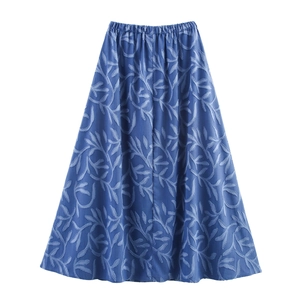 Detail of blue midi skirt featuring leaf pattern texture and elastic waistband