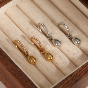 Pair of gold and silver stainless steel hoop earrings with sparkling zircon teardrop charms