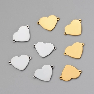Detailed view of dual-hole heart connectors in gold and silver for DIY jewelry making