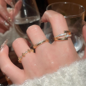 Detailed view of layered 18k gold plated zircon rings with sparkling crystal settings