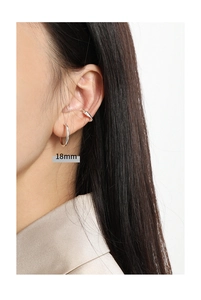 Detailed view of 18mm silver hoop earring and matching ear cuff on model ear