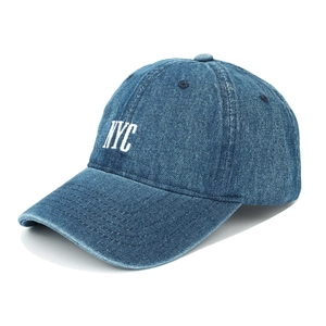 Detail view of vintage washed denim baseball cap with white NYC embroidery and worn texture