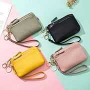 Flat lay of vintage oil wax leather coin purses in grey, black, yellow and pink colors