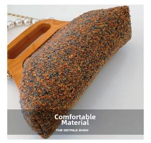 Detailed close-up of retro bouclé fabric texture and wooden handle of the evening bag