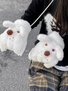 Close-up of white plush dog gloves with fluffy texture and neck strap details
