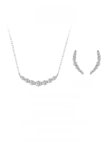 Macro shot of S925 silver necklace and earring set with brilliant curved diamond rows