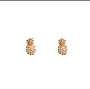 Detailed view of elegant gold pineapple stud earrings featuring white micro pearls