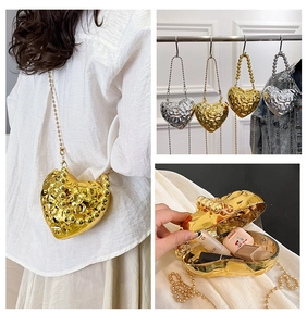 Detailed views of heart-shaped hammered metal evening bag with bead chain strap