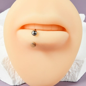 Close-up of G23 titanium spike lip ring on a silicone model with silver finish