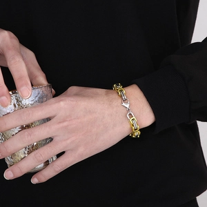 Close-up of a two-tone gold and silver 8mm hip-hop chain bracelet on a male model