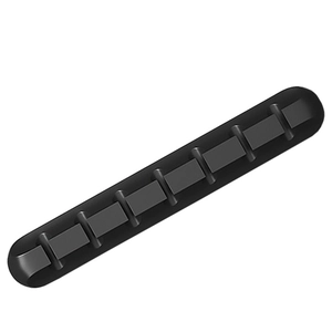 Black silicone cable organizer with multiple slots for USB cord management on white background